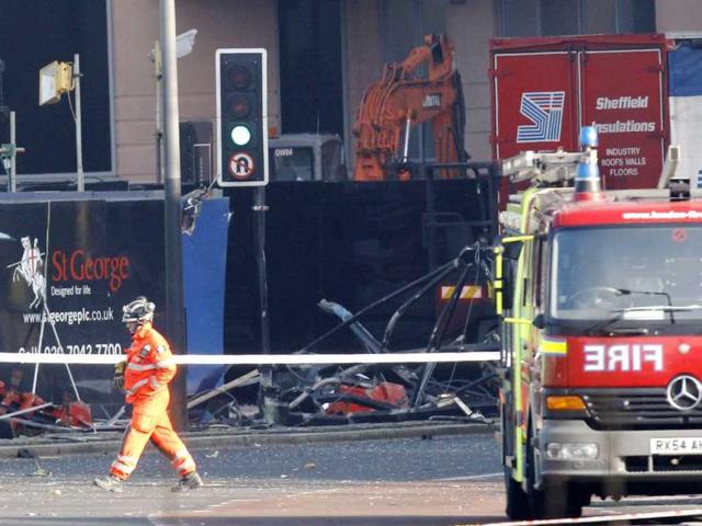 A broken section from a crane is seen lying on the pavement in a road at Vauxhall in London. A helicopter crashed into a crane on top of one of Europe's tallest residential blocks in central London on Wednesday, killing two people as it burst into flames and threw plumes of smoke into the foggy air. Reuters photo