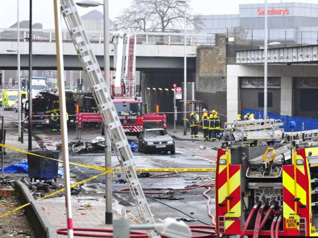 Debris lies on the ground after a helicopter crashed into a construction crane on top of St George's Wharf tower building, in London. AP photo