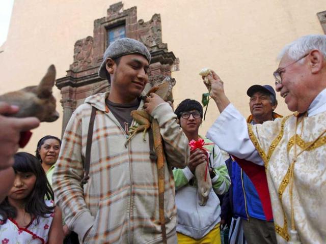 A priest blesses an iguana in a church in Xochimilco, on the outskirts of Mexico City. People take their animals to churches to be blessed during the day of Saint Anthony Abate, the patron saint of domestic animals. Reuters photo