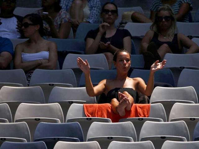 A fan applauds during the men's singles match between Jeremy Chardy of France and Andreas Seppi of Italy at the Australian Open tennis tournament in Melbourne. Reuters
