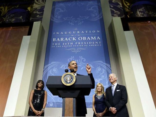 US first lady Michelle Obama, Dr Jill Biden and US vice president Joseph R Biden listen while US President Barack Obama speaks to supporters during an inauguration reception at the National Building Museum in Washington, DC. AFP Photo