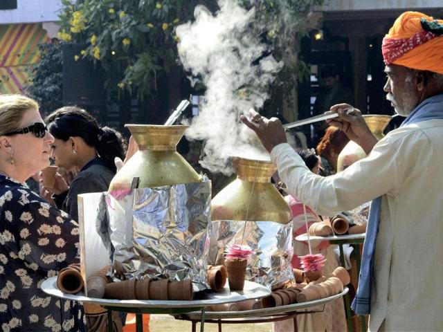 A vendor serves tea in earthen cups to visitors during Jaipur Literature Festival in Rajasthan. PTI