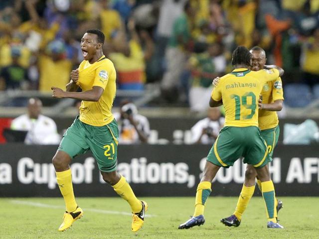 South Africa's Siyabonga Sangweni, left, celebrates scoring, along with teammates Thulani Serero, right, and May Mahlangu, in their African Cup of Nations Group A soccer match, in Durban, South Africa. AP Photo