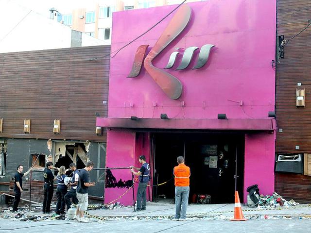 Police investigators inspect the entrance of the Kiss nightclub in Santa Maria city, Rio Grande do Sul state, Brazil. Flames raced through a crowded nightclub in southern Brazil early Sunday, killing more than 230 people as panicked partygoers gasped for breath in the smoke-filled air, stampeding toward a single exit partially blocked by those already dead. AP Photo