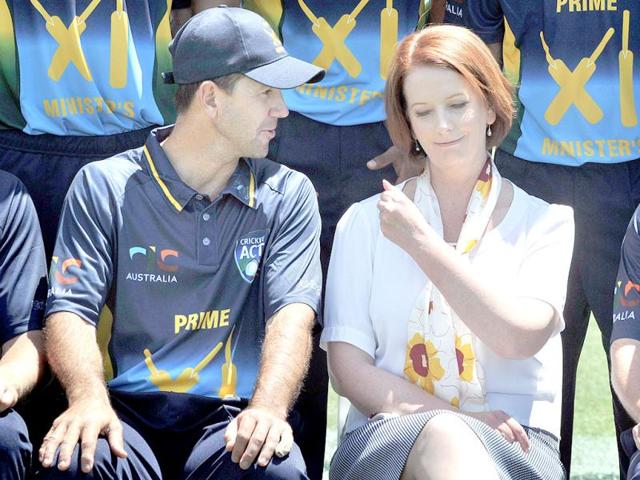 Australia's Prime Minister Julia Gillard (R) chats with cricketer Ricky Ponting (L) before the start of the cricket match between the West Indies and the Prime Minister's XI squad at Manuka Oval in Canberra. AFP PHOTO
