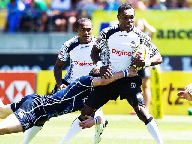 Fiji's Manasa Nayagi is tackled by Scotland's Struan Dewar with Fiji's Joji Baleviani Raqamate in support during their pool D match at the Westpac Stadium on the fourth leg of the IRB Sevens World Series in Wellington. AFP/Marty Melville