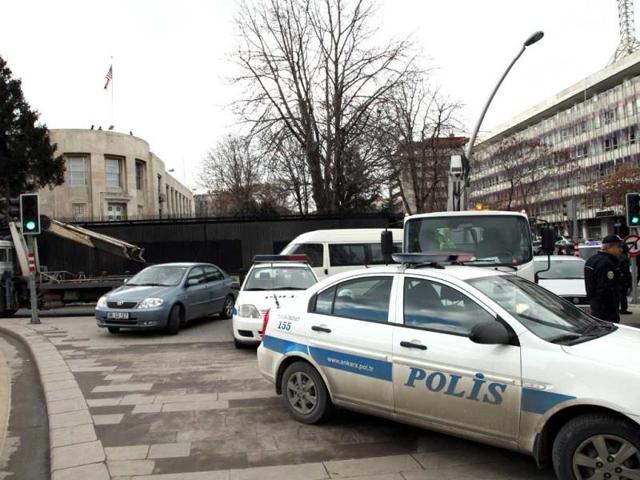 Security cars surround the US Embassy in Ankara, after a suspected suicide bomber detonated an explosive device. AP