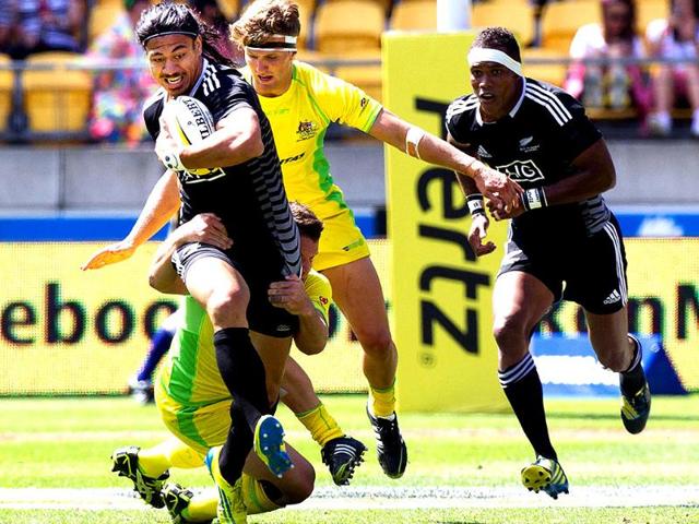 New Zealand's Ben Lam is tackled by Australia's Ben Adams and Lewis Holland with New Zealand's Lote Raikabula in support during their Cup Quarter Final game at the Westpac Stadium on day two of the fourth leg of the IRB Rugby Sevens World Series in Wellington. AFP/Marty Melville