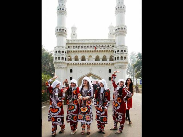Artists from Tajikistan pose in frony of a replica of Charminar during the inauguration of the Surajkund International Crafts Mela at Surajkund, Haryana. PTI