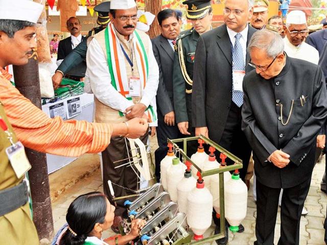 President Pranab Mukherjee at a stall during inauguration of the Surajkund International Crafts Mela at Surajkund, Haryana. PTI