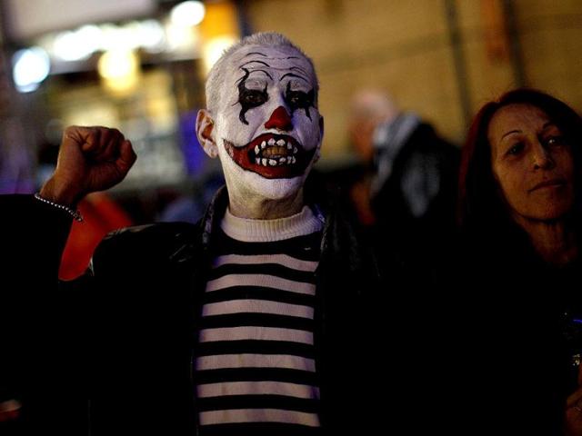A demonstrator who is dressed up for the carnival shouts slogans during a protest against political corruption at La Constitucion Square in Malaga, southern Spain. REUTERS/Jon Nazca