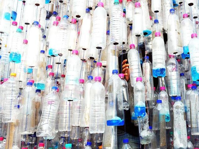 A visitor walks out of an art installation made from used plastic bottles to create awareness about the harmful effects of plastics at the annual Kala Ghoda Arts Festival in Mumbai on February 4, 2013. (AFP PHOTO)