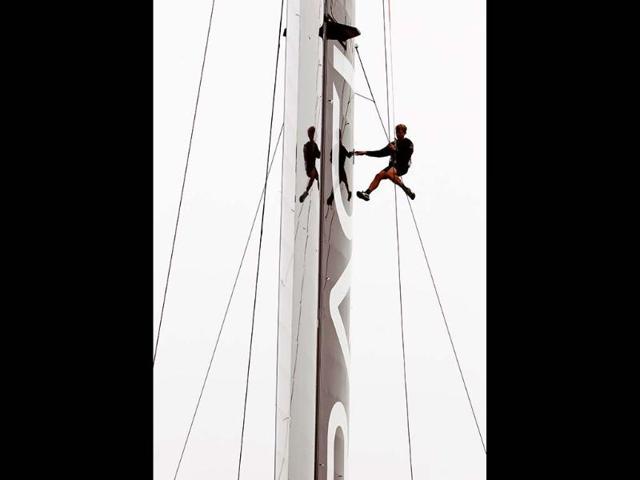 Rigger Dean Curtis works on the wing sail of Oracle Team USA's AC72 racing yacht after it was hoisted into the water at the defending America's Cup champions headquarters at Pier 80 on San Francisco Bay in San Francisco, California. Reuters/Robert Galbraith