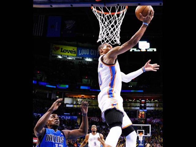 Oklahoma City Thunder guard Russell Westbrook goes to the basket in front of Dallas Mavericks guard Mike James (13) during the first half of an NBA basketball game in Oklahoma City. Oklahoma City won 112-91. AP/Alonzo Adams