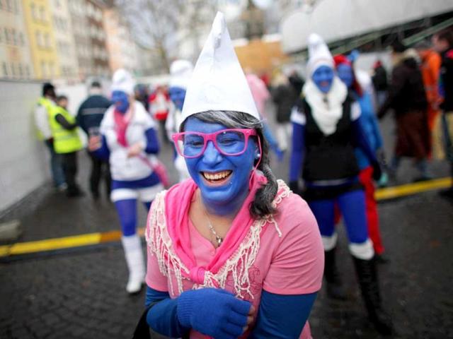 A woman dressed as a smurf celebrates the beginning of the street carnival in Cologne, western Germany as the hot carnival season was launched. AFP Photo