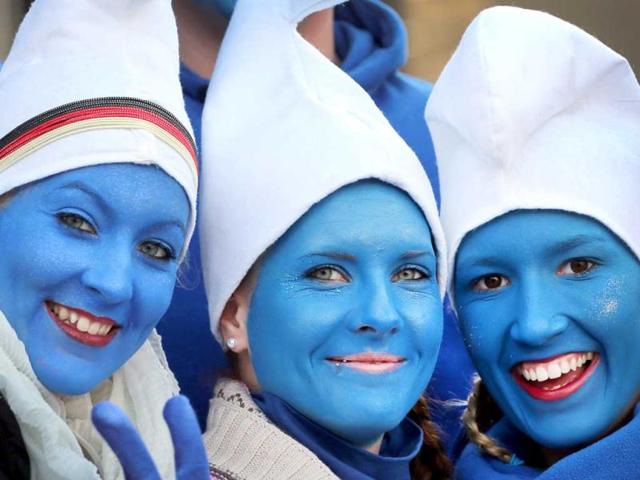 Women dressed as smurfs celebrate the beginning of the street carnival in Cologne, western Germany as the hot carnival season was launched. AFP Photo