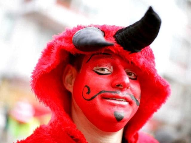 A fool celebrates the beginning of the street carnival in Cologne, western Germany as the hot carnival season was launched. AFP Photo