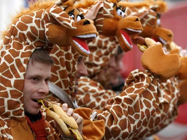 Men dressed in giraffe costumes eat sausages during "Weiberfastnacht" (Women's Carnival) in Cologne. Reuters