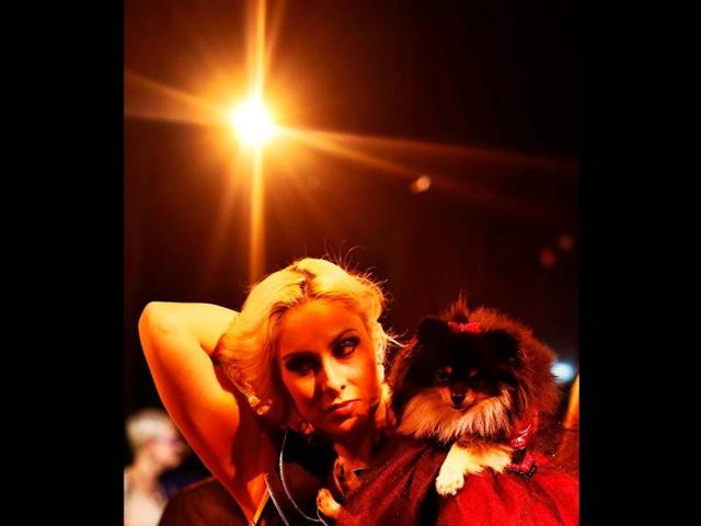 Victoria Viscardi brushes back her hair while holding her dog Gia Marie, a Pomeranian breed, before the start of the New Yorkie Runway Doggie Fashion Show in New York. Reuters/Shannon Stapleton