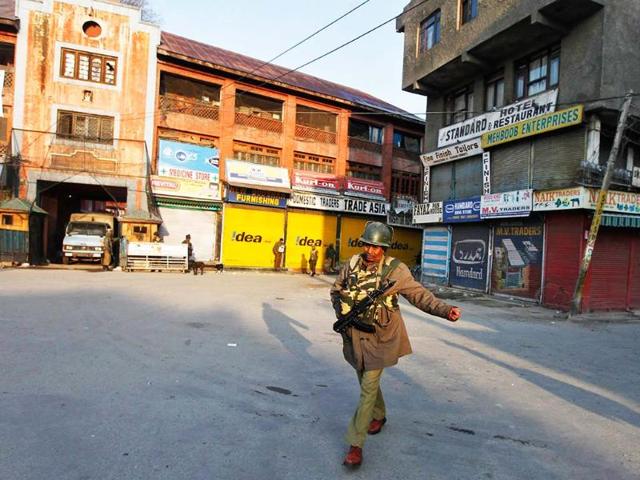 A policeman patrols a deserted road during restriction in Srinagar after Afzal Guru was hanged for plotting the 2001 Parliament attack. Reuters/Danish Ismail