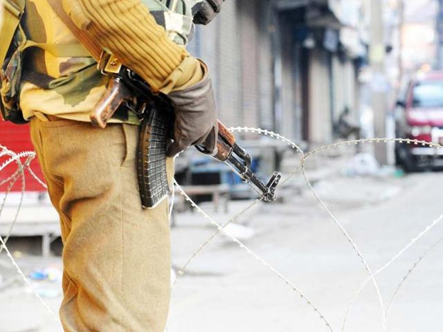 A paramilitary soldier stands guard on a deserted street during a curfew in Srinagar. AFP