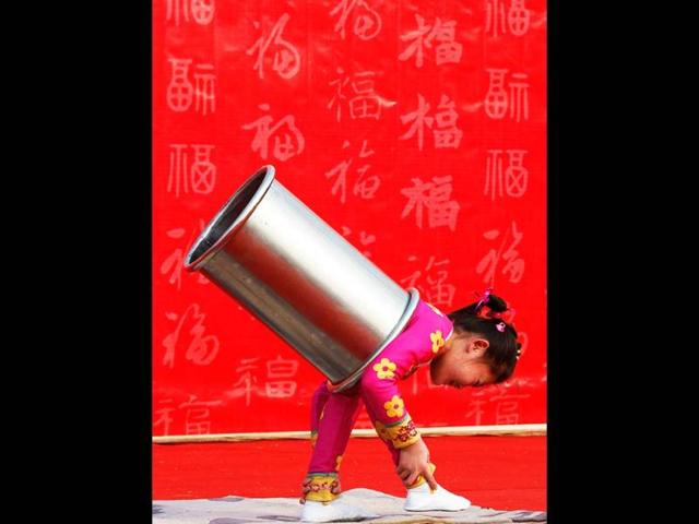 A girl performs an acrobatic show during the temple fair in Ditan Park, also known as the Temple of Earth, in Beijing. Reuters
