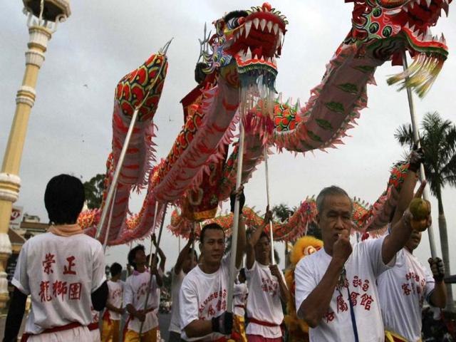 Ethnic Cambodian Chinese community people perform a dragon dance in front of the Royal Palace ahead of Lunar New Year, in Phnom Penh, Cambodia. (AP Photo)