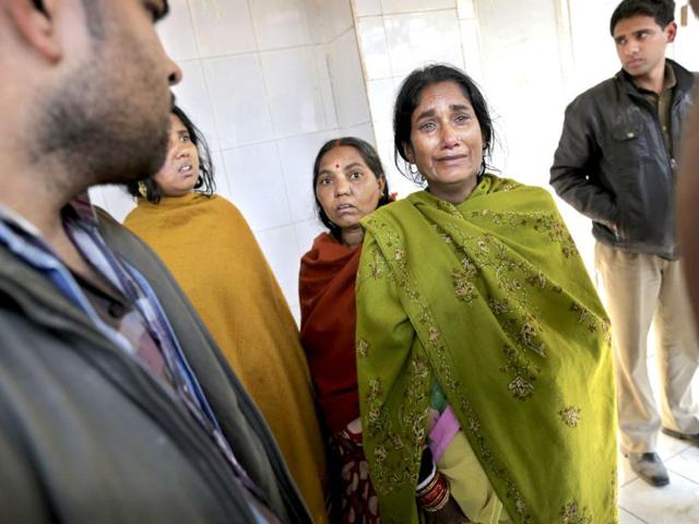 Relatives of a devotee who died in a stampede at a railway station, arrive to identify the body of a loved one at a local morgue in Allahabad. AP Photo