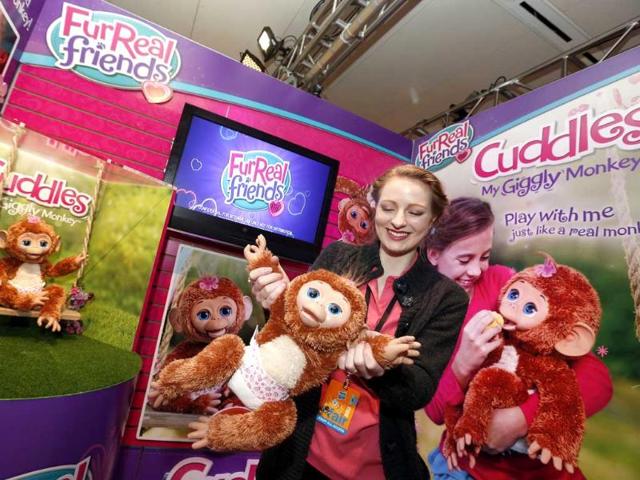 My giggly monkey takes a swing with demonstrator Christa Sparks in Hasbro's showroom at the American International Toy Fair in New York. AP/Jason DeCrow/Invision for Hasbro