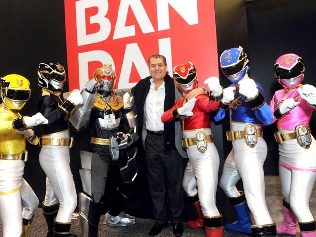 Haim Saban, creator of Power Rangers and chairman and CEO of Saban Capital Group, poses with the Rangers outside the Bandai booth at the American International Toy Fair in New York. AP/Diane Bondareff/Invision for Saban Brands