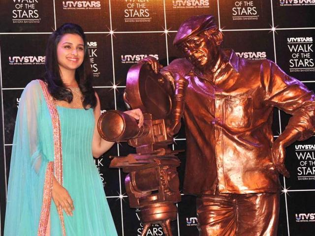 Parineeti Chopra looked pretty in an aquamarine suit as she posed next to Yash Chopra's bronze statue.