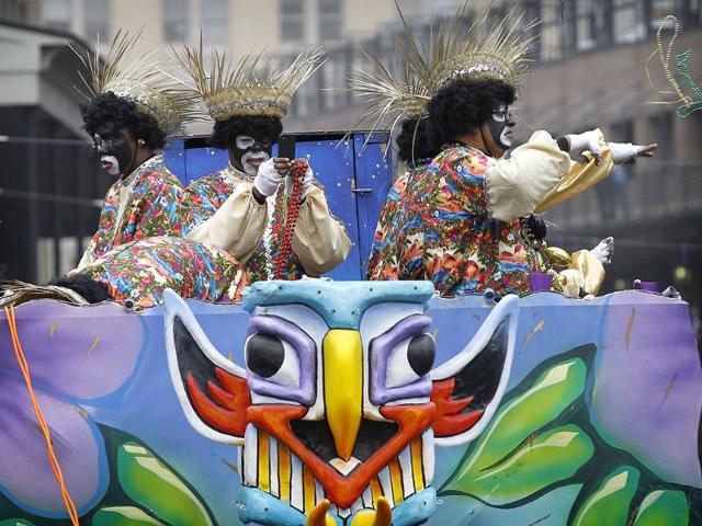 Riders in the Krewe of Zulu parade toss beads to the crowd below on St Charles Avenue in New Orleans on Mardi Gras Day. AFP photo