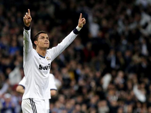 Real Madrid's Portuguese forward Cristiano Ronaldo celebrates after scoring during the UEFA Champions League match between Real Madrid and Manchester United at the Santiago Bernabeu stadium in Madrid. AFP