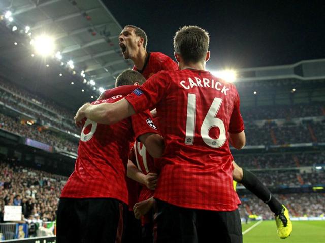 Manchester United's Rio Ferdinand celebrates with teammates after Danny Welbeck scored the opening goal during the Champions League match between Real Madrid and Manchester United at the Santiago Bernabeu stadium in Madrid. AP