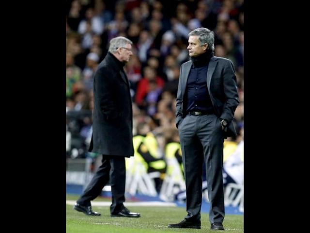 Real Madrid's coach Jose Mourinho reacts in front of Manchester United's manager Sir Alex Ferguson during their Champions League soccer match at Santiago Barnabeu stadium in Madrid. Reuters