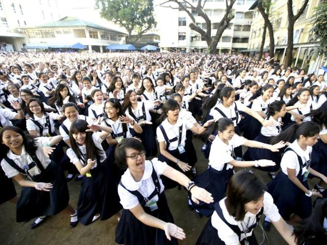 Students and Roman Catholic nuns of St. Scholastica's College, an all-girls' school, dance to kickoff a global campaign dubbed One Billion Rising on Valentine's Day in Manila, Philippines. (AP Photo)