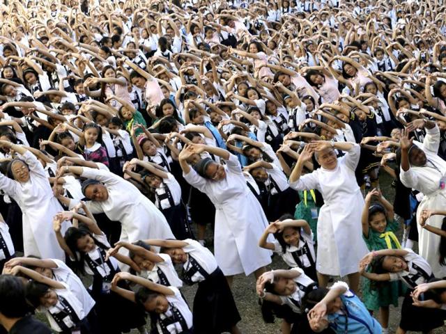 Students and Roman Catholic nuns of St. Scholastica's College, an all-girls' school, dance to kickoff a global campaign dubbed One Billion Rising on Valentine's Day in Manila, Philippines. (AP Photo)