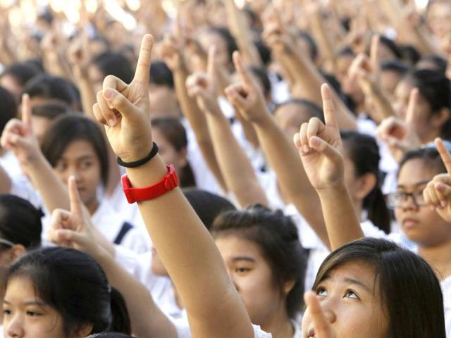 Thousands of students and faculty members dance to the theme song of the One Billion Rising campaign in the quadrangle of the St. Scholastica college in Manila. (Reuters)
