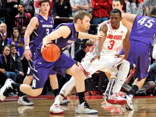 Shannon Scott #3 of the Ohio State Buckeyes guards Alex Marcotullio #4 of the Northwestern Wildcats in the second half at Value City Arena in Columbus, Ohio. AFP/Jamie Sabau/Getty Images