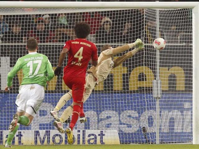 Bayern goalkeeper Manuel Neuer saves a free kick during the German first division Bundesliga soccer match between VfL Wolfsburg and FC Bayern Munich in Wolfsburg, Germany. (AP Photo)