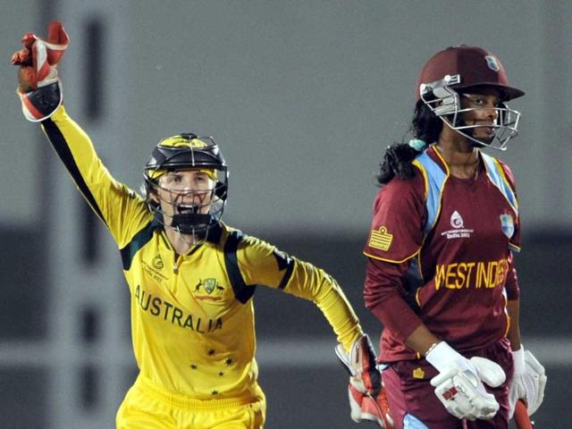 Australian cricketer Jodie Fields (L) celebrates the dismissal of West Indies cricketer Merissa Aguilleria during the final match of the ICC Women's World Cup 2013 between Australia and West Indies at the Cricket Club of India's Brabourne stadium in Mumbai. AFP Photo