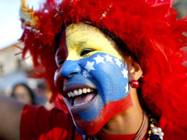 A supporter of Venezuela's President Hugo Chavez cheers outside the military hospital after his surprise return to Caracas. Reuters/Jorge Silva