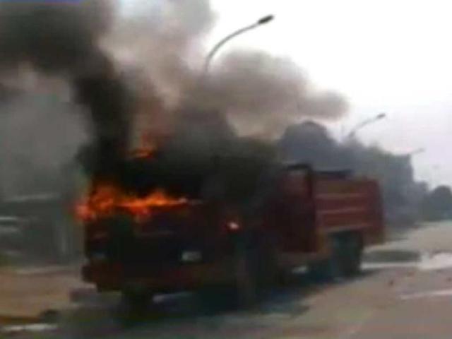 Protesters put a truck on fire during the 2-day trade union strike in Noida. (TV grab)