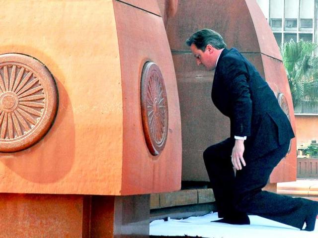 British Prime Minister David Cameron pays his respects at Jallianwala Bagh, the site of a notorious 1919 massacre of hundreds of Indians by British forces, in Amritsar. AP photo