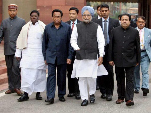 Prime Minister Manmohan Singh, flanked by parliamentary affairs minister Kamal Nath and ministers of state V Narayanasamy and Rajiv Shukla, arrives at Parliament House on the first day of the budget session in New Delhi. PTI/Manvender Vashist