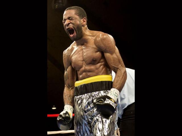 Lamont Peterson celebrates after knocking down Kendall Holt in the sixth round during the IBF Junior Welterweight World Championship match at the DC Armory in Washington, DC. Peterson defeated Holt in the 8th round to remain champion. AFP PHOTO