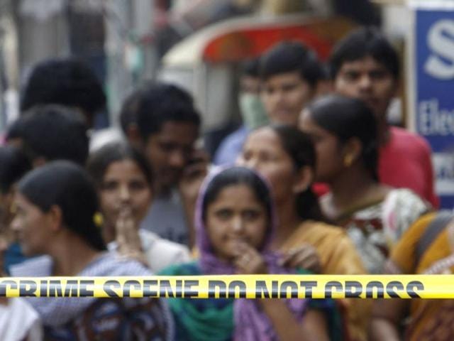 People are seen at one of the two bomb blast sites in Hyderabad. The probe into Thursday's twin blasts gathered momentum with the police scanning the image of a suspect captured on CCTV camera. AP/Mahesh Kumar A