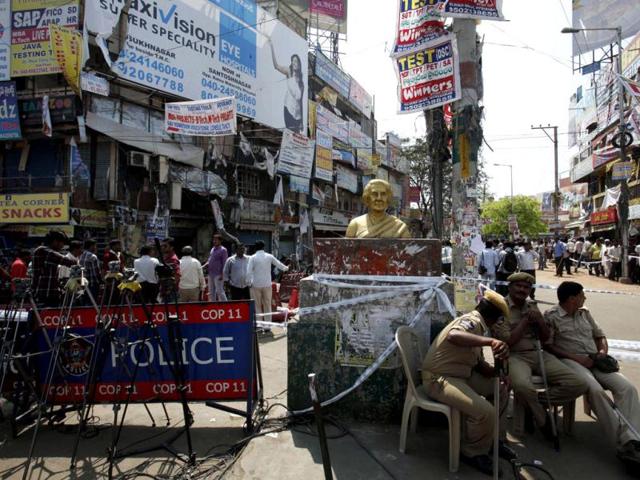 Police guard the site of one of the two bomb blasts in Hyderabad. A man believed to be in his early thirties was seen reaching a traffic signal near the blast site in Dilsukhnagar on a bicycle with a bag hung to its carrier a few minutes before the blasts. AP/Mahesh Kumar A