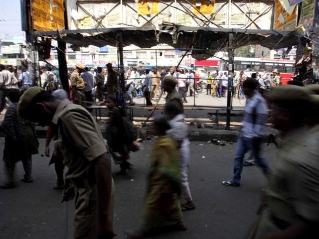 Policemen and others walk past one of the two bomb blast sites in Hyderabad. The suspect was seen reaching the area at 6.38pm, 10 minutes before the blast at Anand Tiffin Centre in front of Konark theatre. AP/Mahesh Kumar A