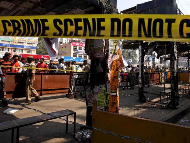 People gather at one of the two bomb blast sites in Hyderabad. As the suspect's face is not clearly visible, the police are taking the help of experts. AP/Mahesh Kumar A